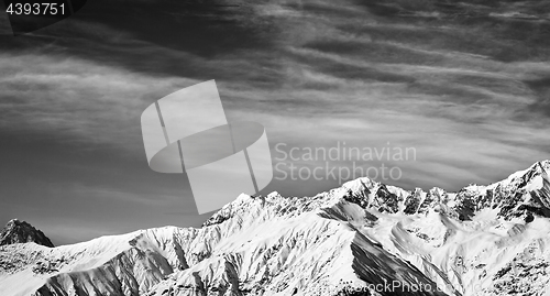 Image of Black and white panoramic view on winter mountains at sun winter
