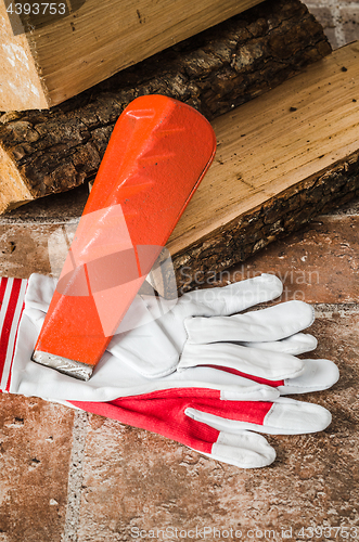 Image of Saw, mittens and firewood, close-up