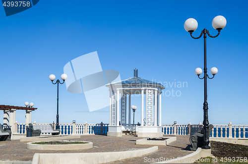 Image of A beautiful romantic gazebo in the park on blue sky background 