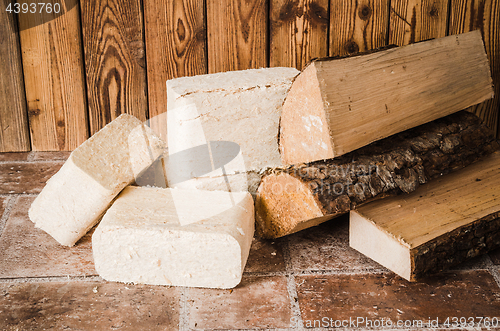 Image of Wood briquette and firewood, close-up