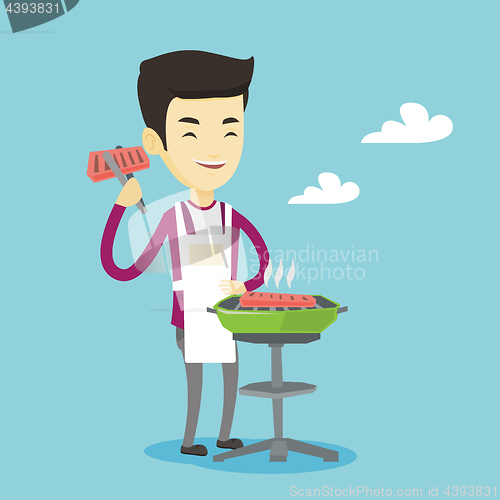 Image of Man cooking steak on barbecue grill.