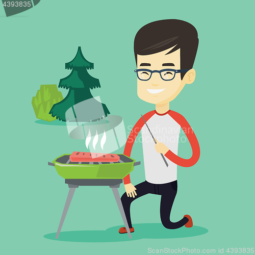 Image of Man cooking steak on barbecue grill.