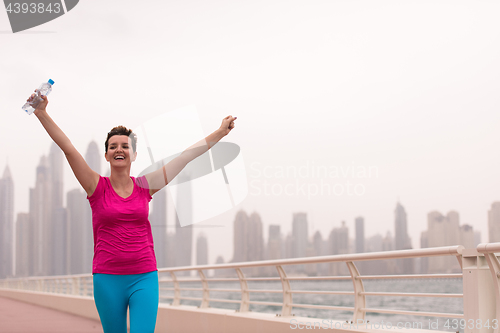 Image of young woman celebrating a successful training run