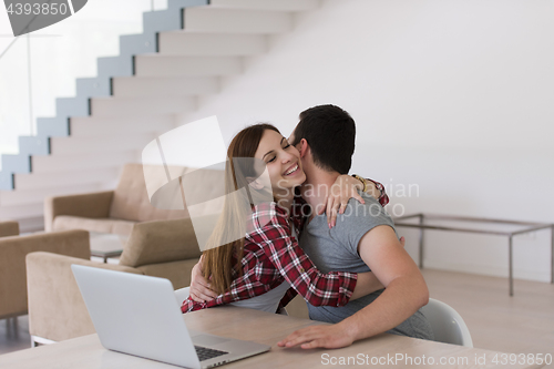 Image of happy young couple buying online