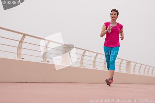 Image of woman busy running on the promenade