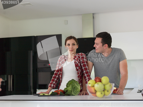 Image of Young handsome couple in the kitchen