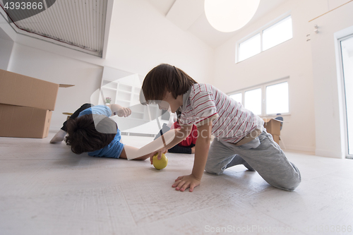 Image of boys having fun with an apple on the floor