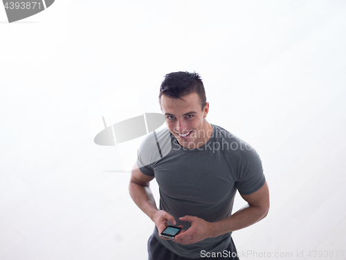 Image of young man using a mobile phone  at home