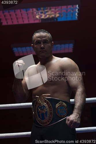 Image of kick boxer with his championship belt