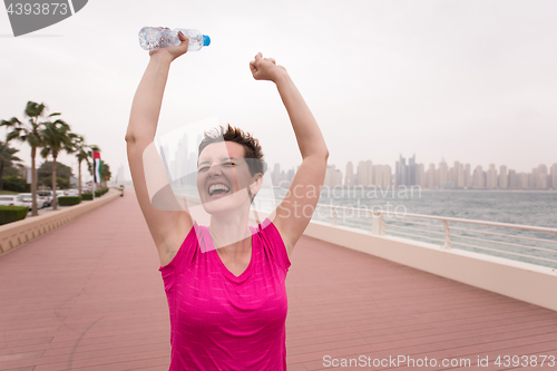 Image of young woman celebrating a successful training run