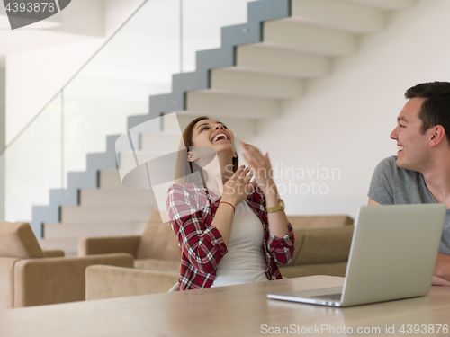 Image of happy young couple buying online