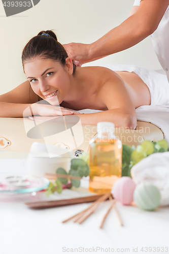 Image of picture of happy beautiful woman in massage salon