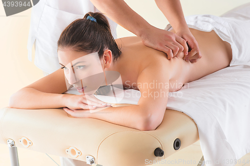 Image of picture of happy beautiful woman in massage salon