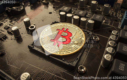 Image of Gold Bit Coin BTC coins on the motherboard. Bitcoin is a worldwi