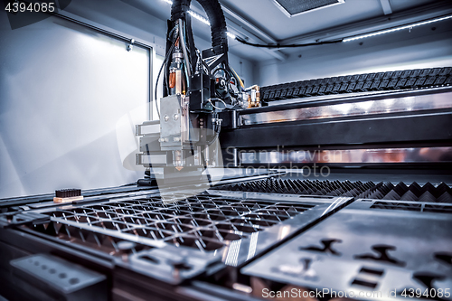 Image of CNC Laser cutting of metal, modern industrial technology.