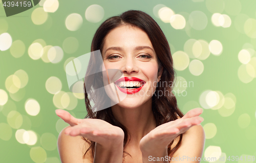 Image of beautiful smiling young woman with red lipstick