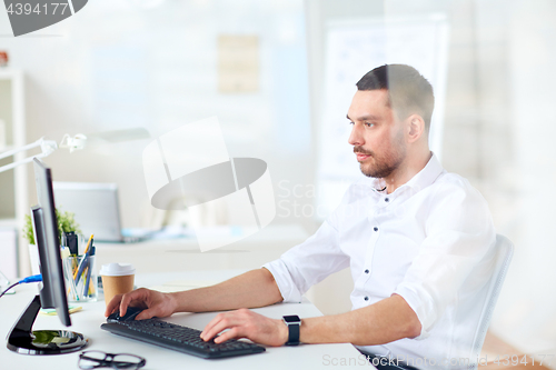 Image of businessman typing on computer keyboard at office