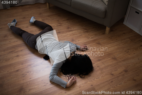 Image of dead woman body in blood on floor at crime scene