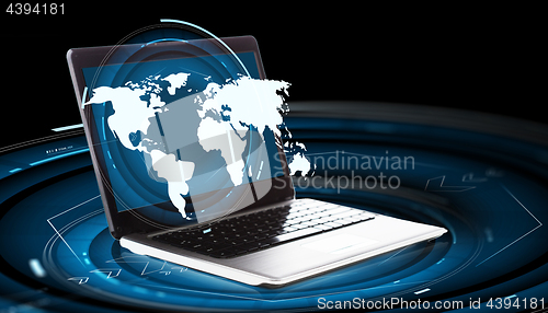 Image of world map hologram and laptop computer