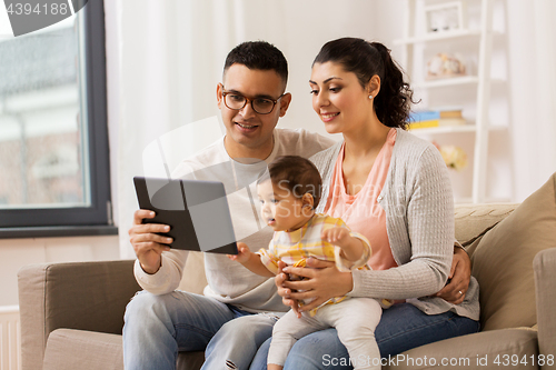 Image of mother, father and baby with tablet pc at home