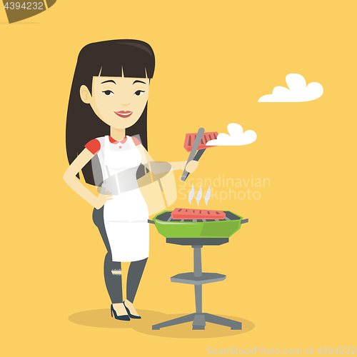 Image of Woman cooking steak on barbecue grill.