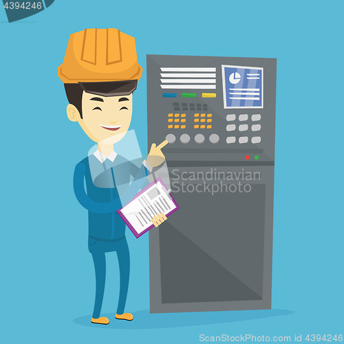 Image of Engineer standing near control panel.