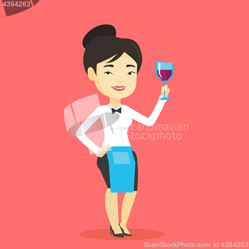 Image of Bartender holding a glass of wine in hand.