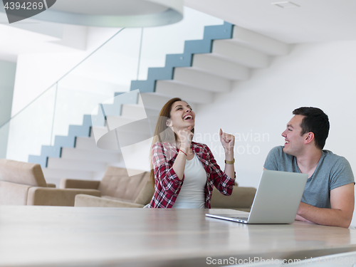 Image of happy young couple buying online