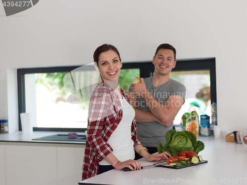 Image of Young handsome couple in the kitchen