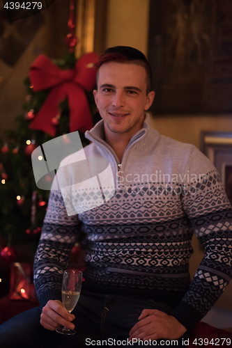 Image of Happy young man with a glass of champagne