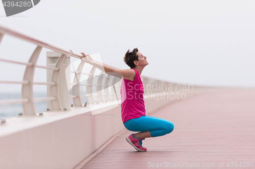 Image of woman stretching and warming up on the promenade