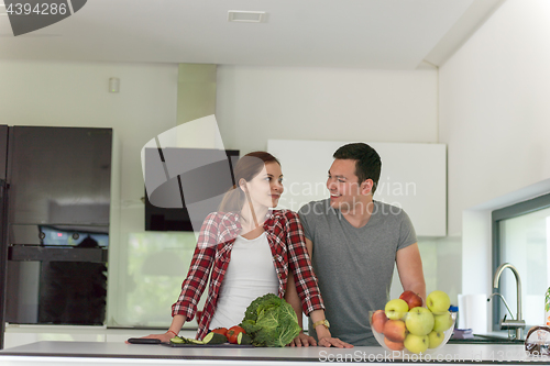 Image of Young handsome couple in the kitchen