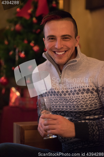 Image of Happy young man with a glass of champagne