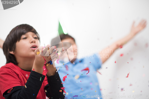 Image of kids  blowing confetti