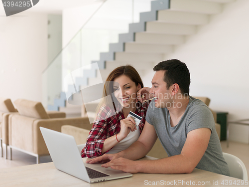 Image of happy young couple buying online