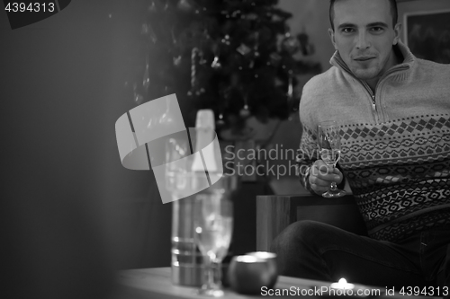 Image of Happy young man with a glass of champagne