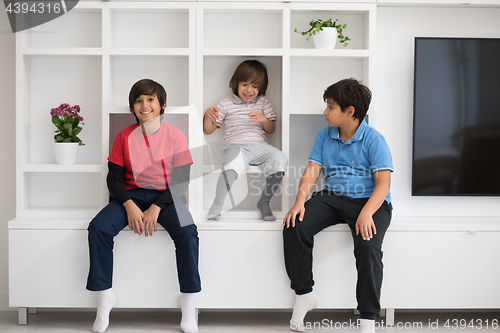 Image of young boys posing on a shelf