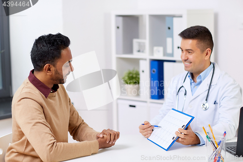 Image of happy doctor and male patient meeting at hospital