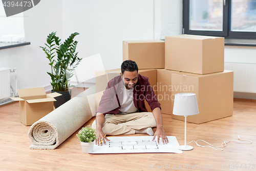 Image of man with boxes and blueprint moving to new home