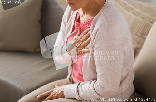 Image of close up of senior woman having heartache at home