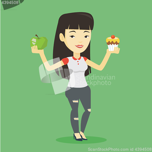 Image of Woman choosing between apple and cupcake.