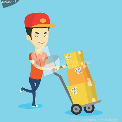 Image of Delivery postman with cardboard boxes on trolley.