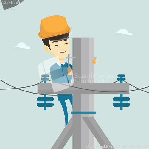 Image of Electrician working on electric power pole.