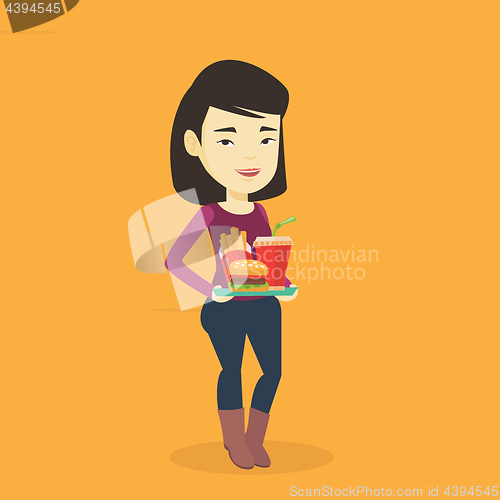 Image of Woman holding tray full of fast food.