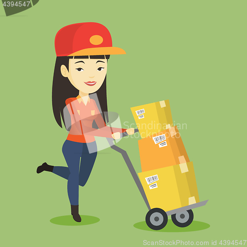 Image of Delivery postman with cardboard boxes on trolley.