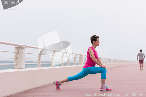 Image of woman stretching and warming up on the promenade