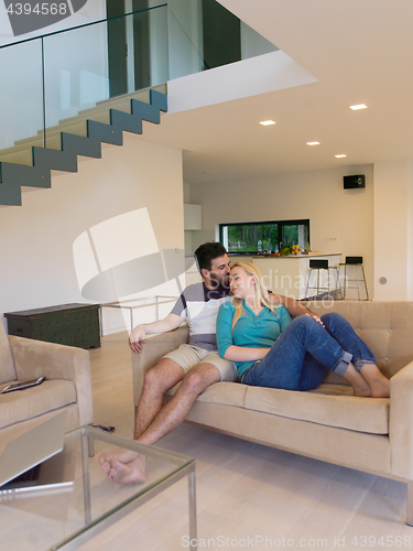 Image of young happy couple relaxes in the living room