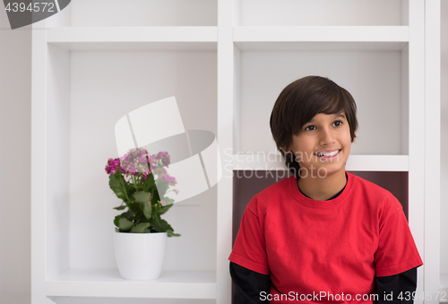 Image of young boy posing on a shelf