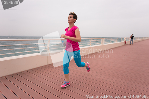 Image of woman busy running on the promenade