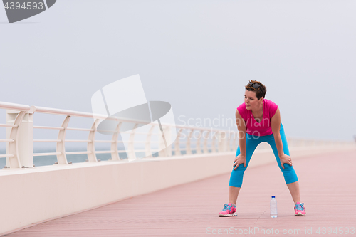 Image of woman stretching and warming up on the promenade